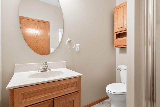 bathroom featuring tile patterned floors, vanity, and toilet