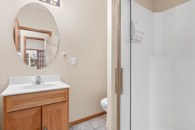 bathroom featuring tile patterned floors, vanity, and toilet