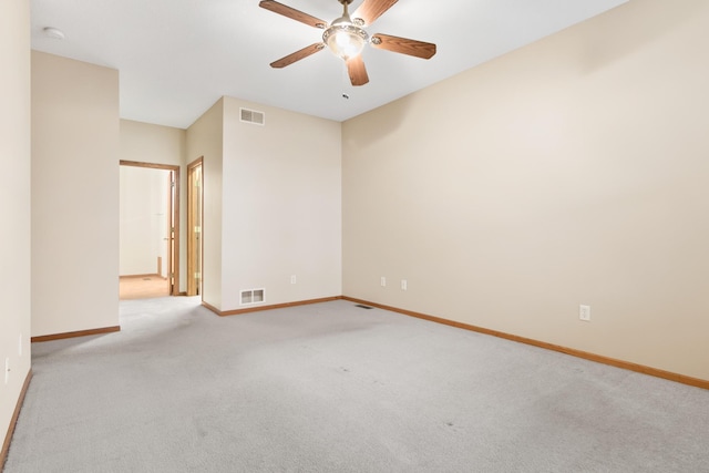 empty room with ceiling fan and light colored carpet