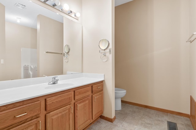 bathroom featuring tile patterned floors, vanity, and toilet