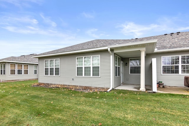 rear view of property featuring a yard and a patio