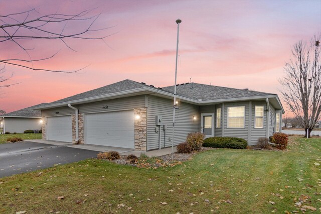 ranch-style house with a lawn and a garage