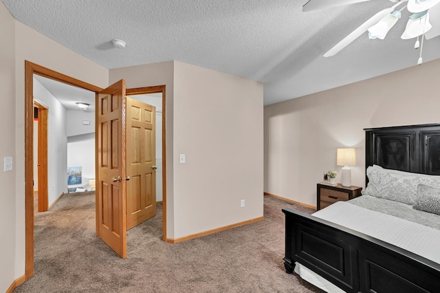 carpeted bedroom featuring ceiling fan, a textured ceiling, and baseboards