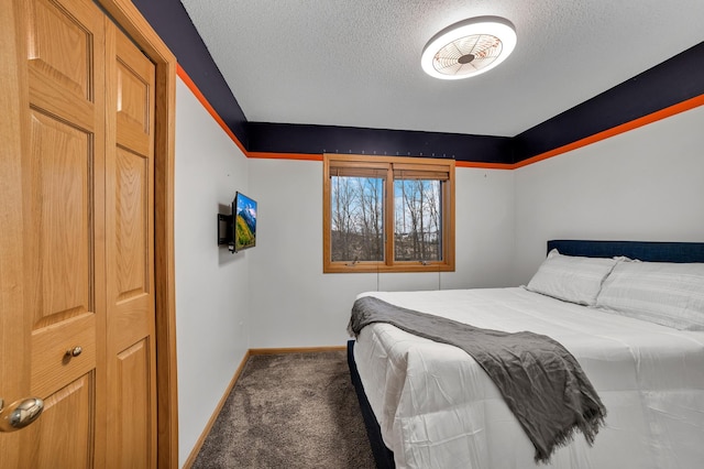 bedroom featuring a textured ceiling, carpet flooring, and baseboards