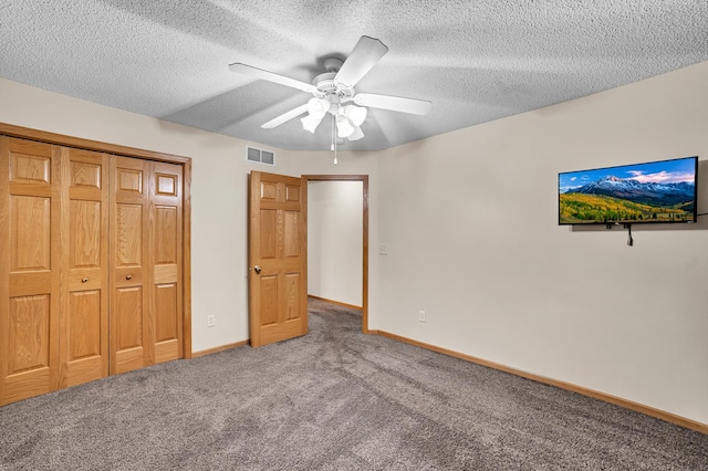 unfurnished bedroom with baseboards, carpet flooring, visible vents, and a textured ceiling