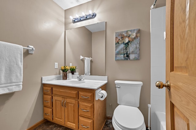 bathroom featuring toilet, baseboards, and vanity