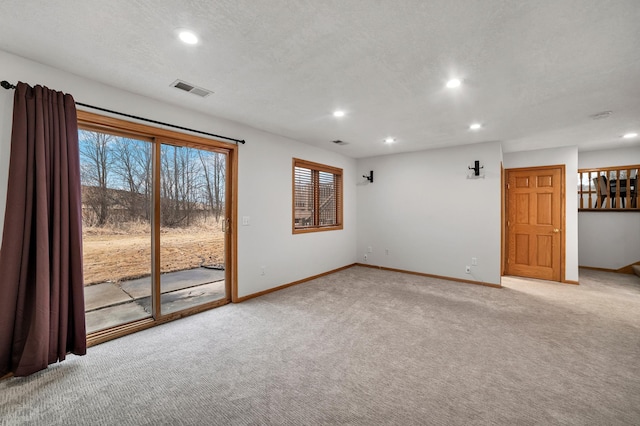 unfurnished room with recessed lighting, visible vents, light carpet, a textured ceiling, and baseboards