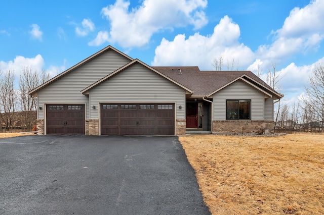 view of front of property with a garage, a shingled roof, aphalt driveway, and brick siding