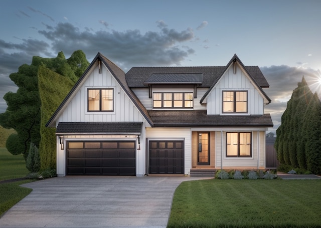 modern inspired farmhouse with a garage and a front lawn