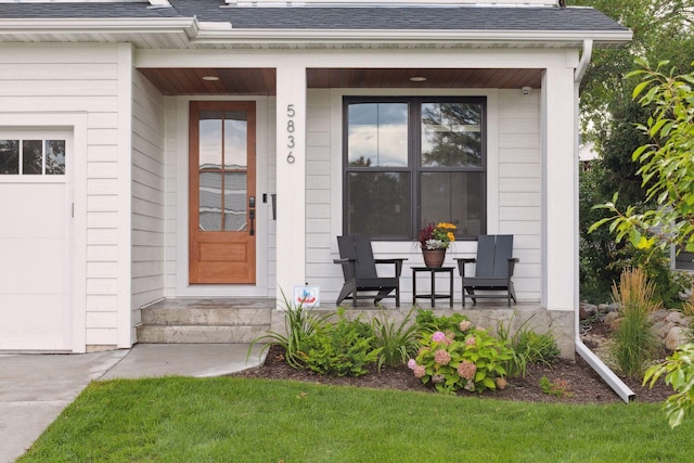 property entrance featuring a garage and covered porch