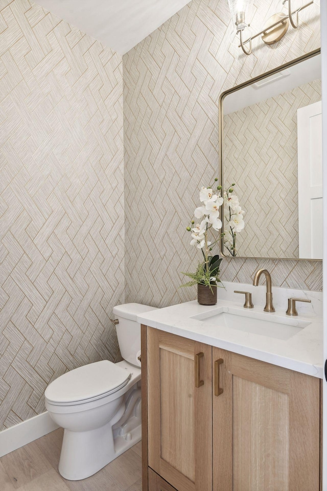 bathroom featuring tile walls, vanity, and toilet