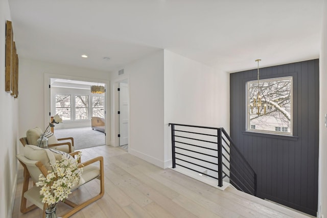 interior space featuring light hardwood / wood-style flooring and a chandelier