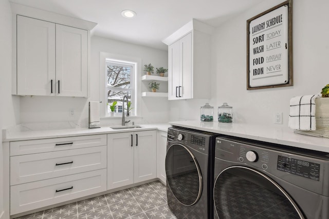 laundry room with cabinets, sink, and washing machine and dryer