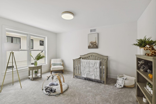 bedroom with a crib and carpet flooring