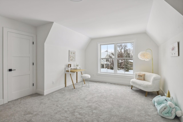 sitting room with lofted ceiling and carpet flooring