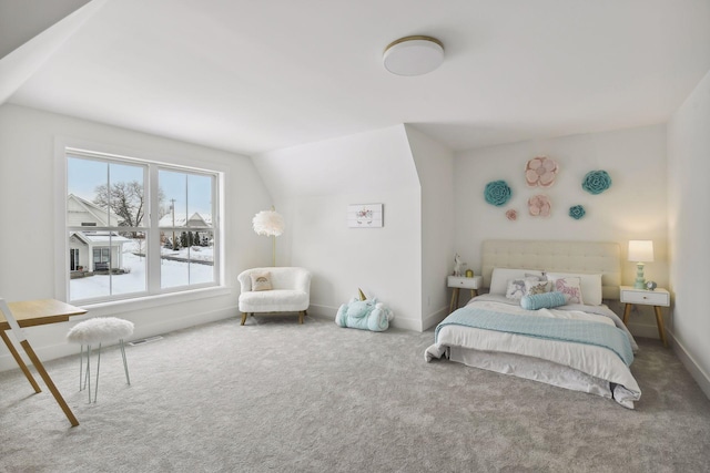 bedroom featuring carpet and vaulted ceiling