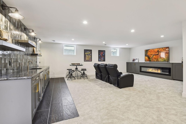 living room featuring indoor wet bar and dark colored carpet