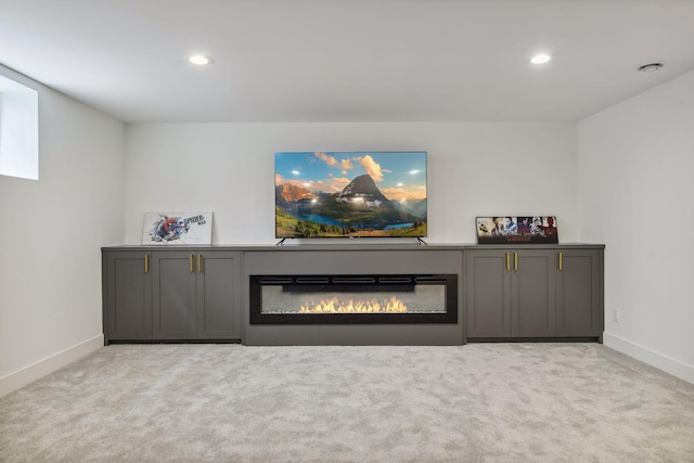 unfurnished living room with light colored carpet