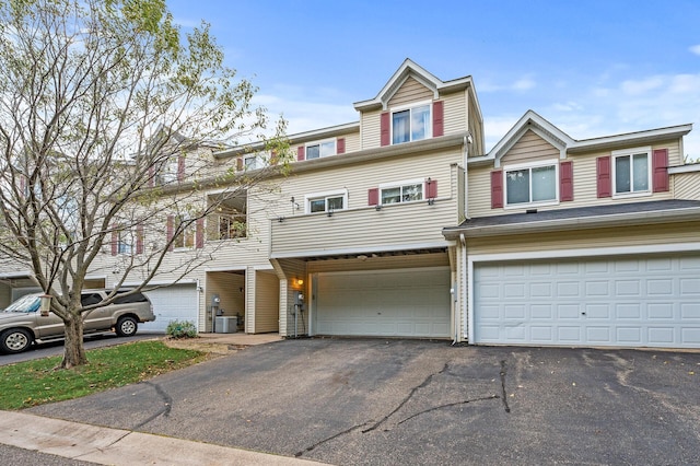 multi unit property featuring a garage and central AC