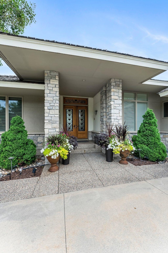 doorway to property featuring stone siding