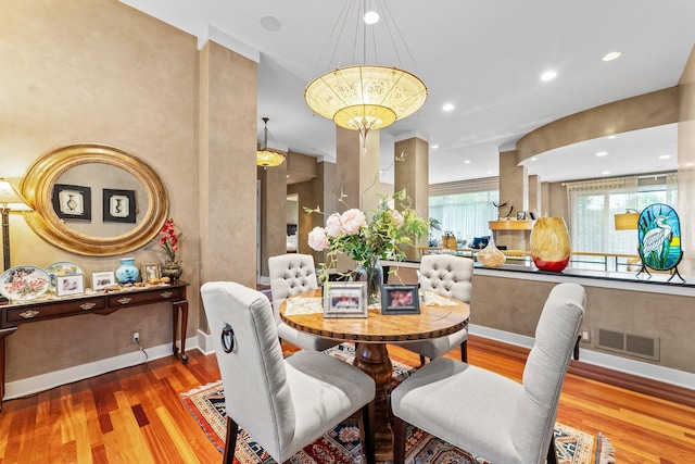 dining room featuring visible vents, baseboards, and wood finished floors