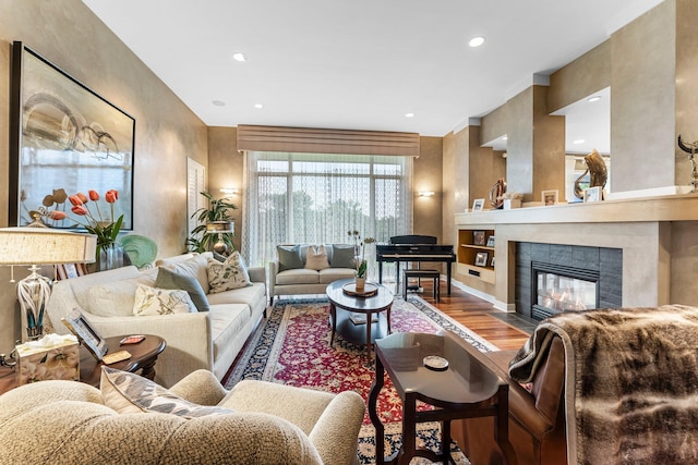 living room featuring wood finished floors, a fireplace, and recessed lighting