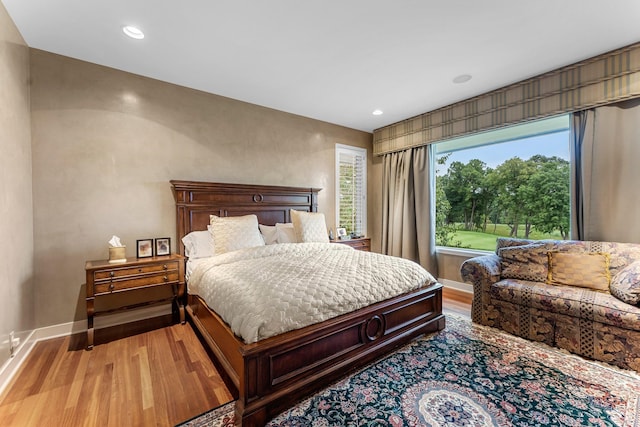 bedroom featuring recessed lighting, light wood-type flooring, and baseboards