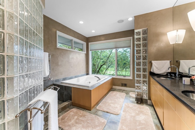 full bathroom featuring recessed lighting, a bath, visible vents, and a sink