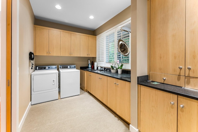 laundry room with baseboards, a sink, recessed lighting, cabinet space, and washer and clothes dryer