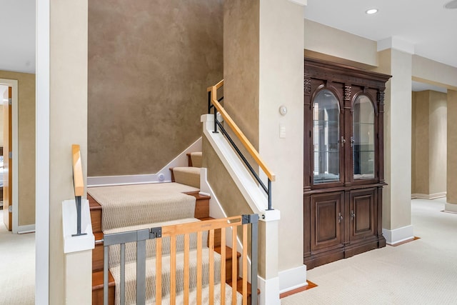 stairs with baseboards, recessed lighting, and carpet flooring