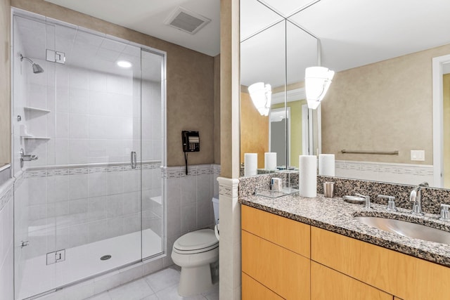 bathroom featuring vanity, a stall shower, tile patterned floors, toilet, and visible vents