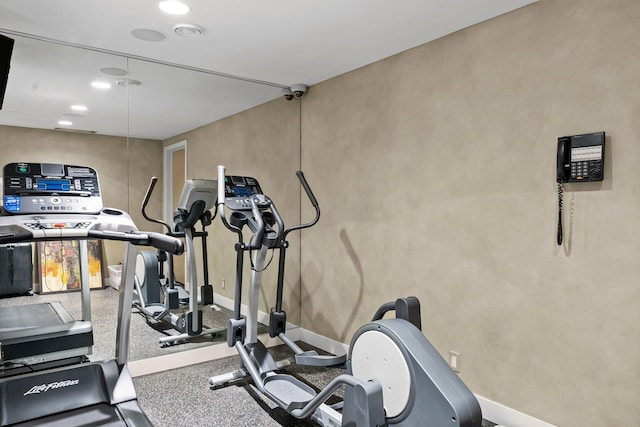 workout area featuring baseboards and recessed lighting