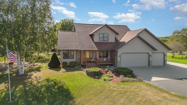 view of front of home featuring a garage, a front lawn, and a porch