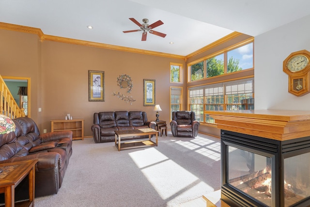 living room with a multi sided fireplace, crown molding, carpet flooring, and ceiling fan