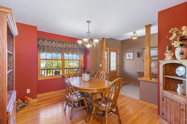 dining room with an inviting chandelier and light hardwood / wood-style flooring