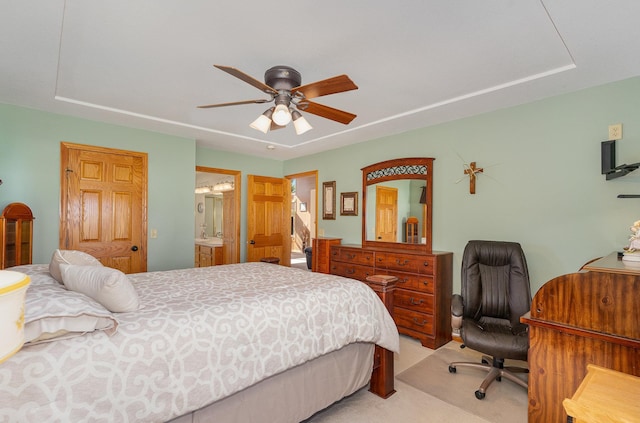 carpeted bedroom featuring ensuite bathroom and ceiling fan