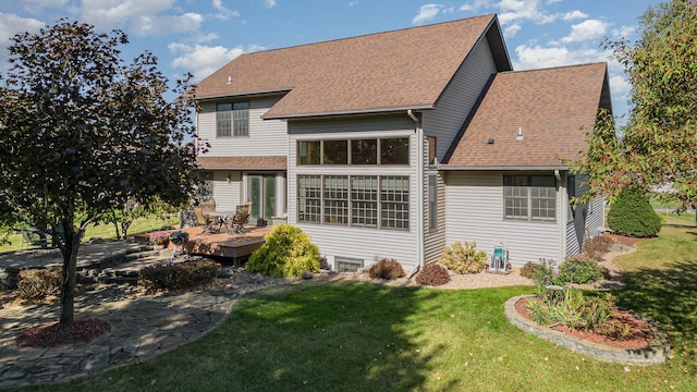 back of property featuring a yard and a deck