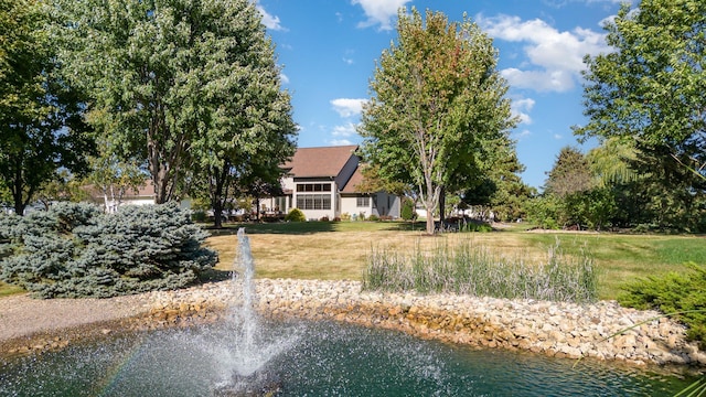 view of property's community featuring a water view and a yard