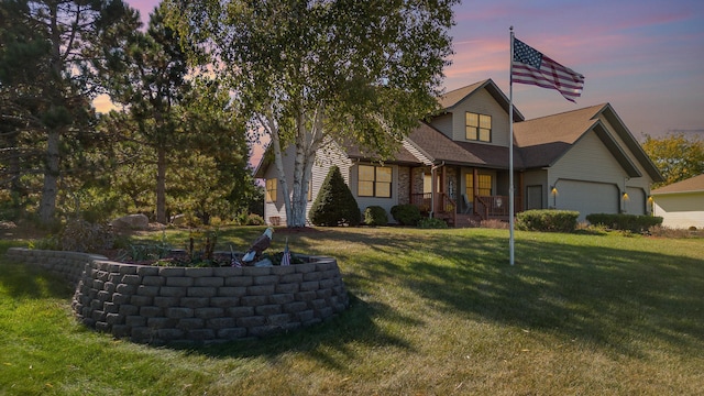 view of front of house featuring a yard and a garage