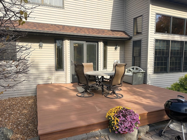 wooden deck featuring a grill