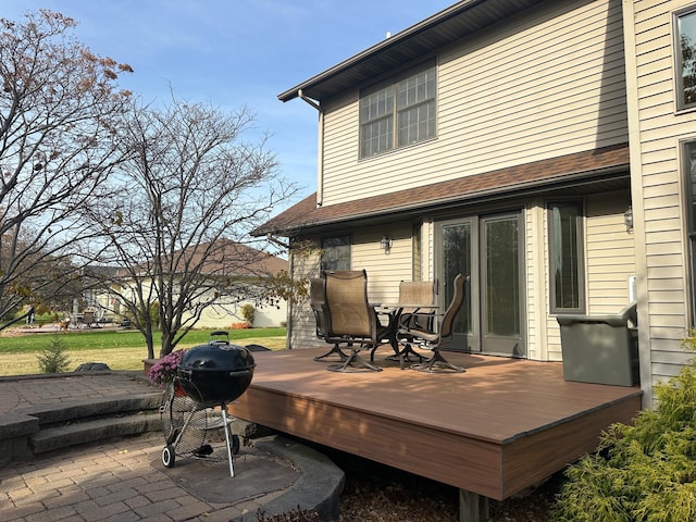 rear view of house with a yard, a patio area, and a deck