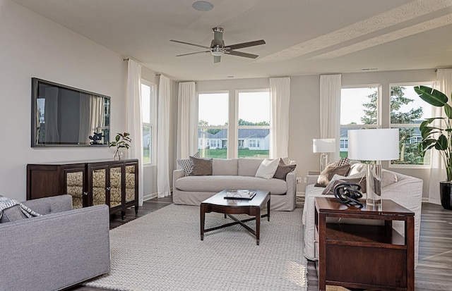 living room featuring dark hardwood / wood-style floors and ceiling fan