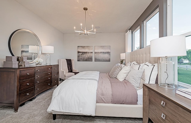 bedroom with light carpet and an inviting chandelier