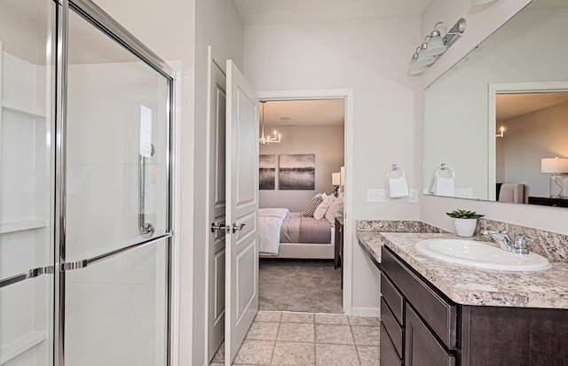 bathroom featuring vanity, tile patterned floors, and a shower with door