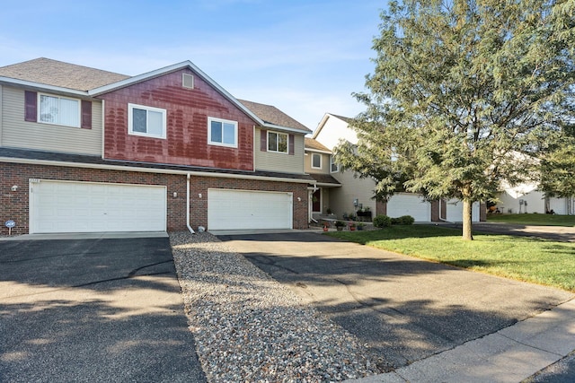 view of front of house with a front yard and a garage