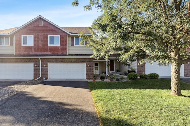 view of front of property with a front lawn and a garage