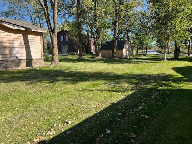 42911 County Highway 53, Pine Lake Twp, MN 56567 - view of green lawn with a storage unit and an outbuilding
