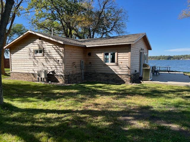 42911 County Highway 53, Pine Lake Twp, MN 56567 - view of home's exterior featuring a lawn and a water view