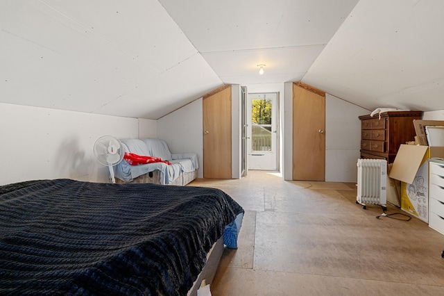 bedroom with radiator and lofted ceiling