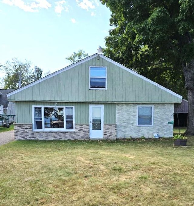 back of property featuring a lawn